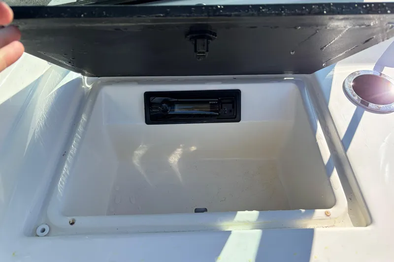 Slide: The Image of Open storage compartment on a 2015 Sea Ray 19 SPX boat with a Sony stereo. - 17