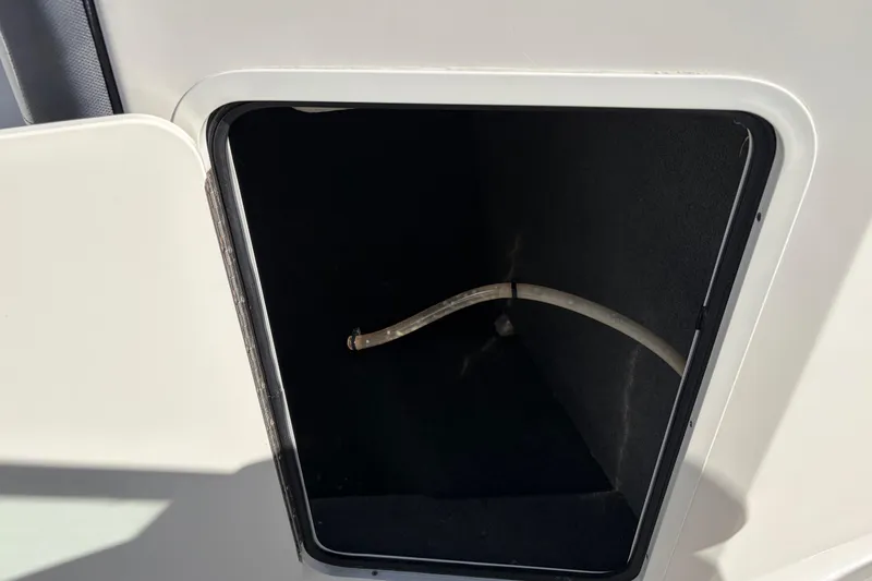 Slide: The Image of Open storage compartment on a 2015 Sea Ray 19 SPX boat. - 18