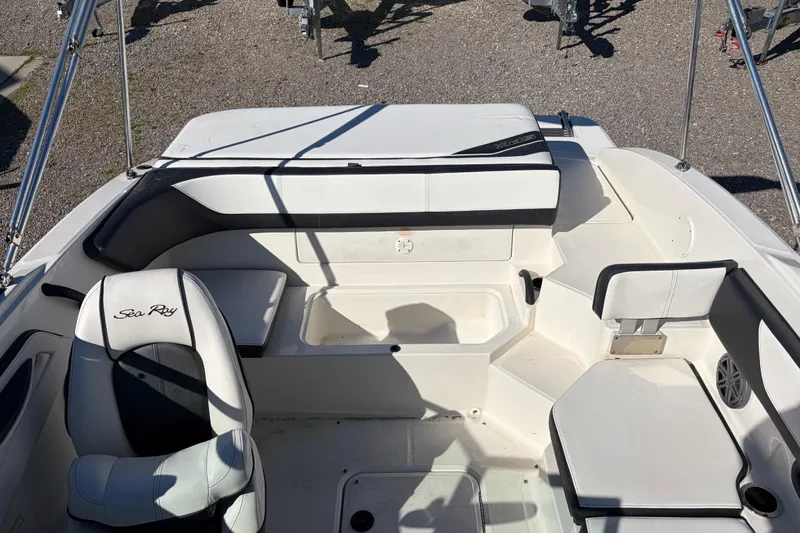 Slide: The Image of 2015 Sea Ray 19 SPX boat interior with white seating and storage compartments. - 9