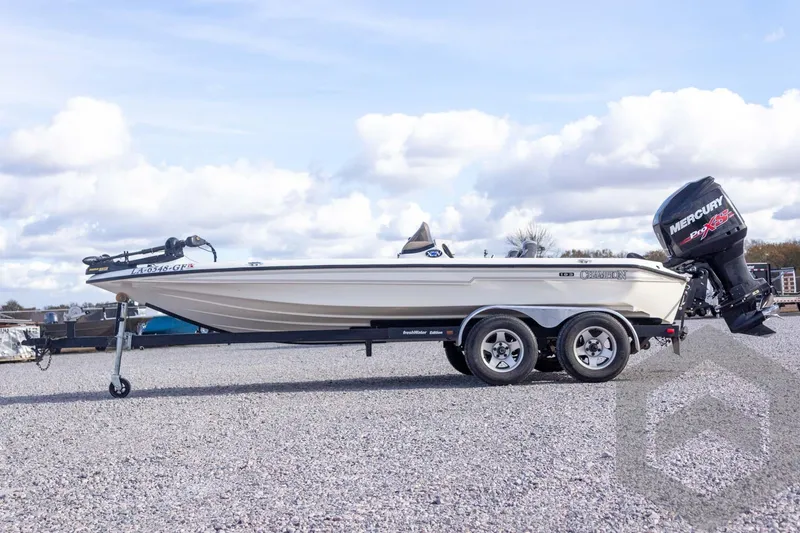 Slide: The Image of 2000 Champion 193 CX boat with Mercury Pro XS engine on trailer, parked outdoors. - 11