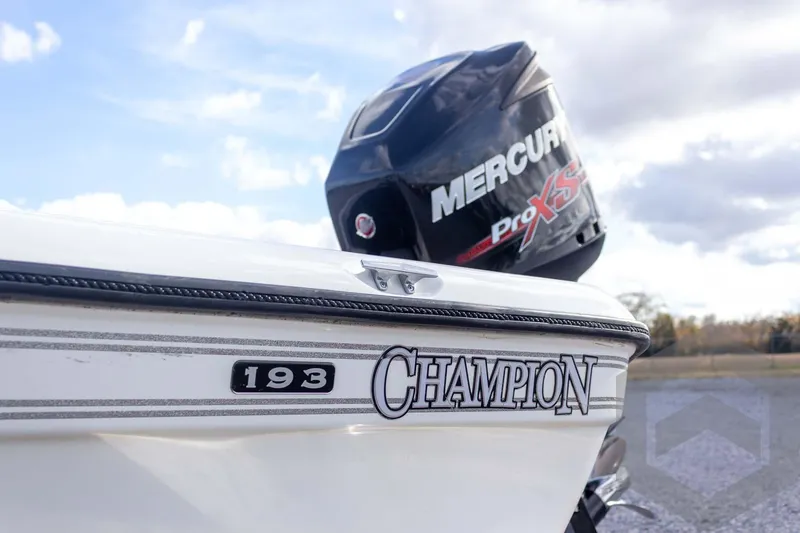 Slide: The Image of Champion 193 CX boat with Mercury Pro XS engine, 2000 model, under a cloudy sky. - 12