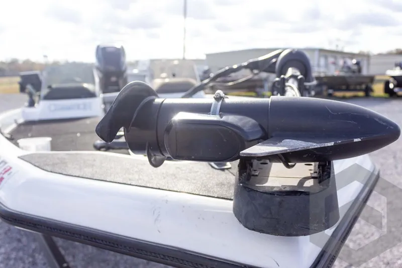 Slide: The Image of 2000 Champion 193 CX boat with trolling motor on deck, outdoor setting. - 14