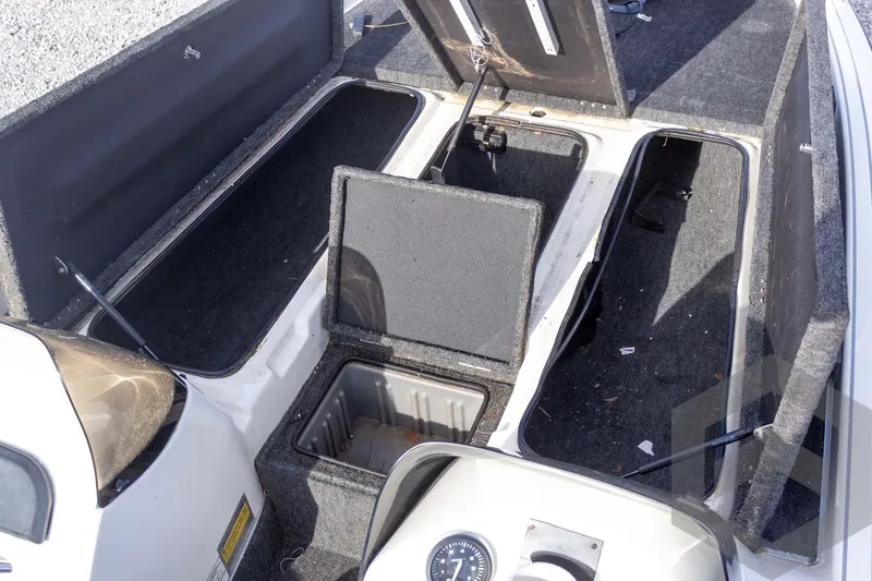 Slide: The Image of Open storage compartments on a 2000 Champion 193 CX boat deck. - 19