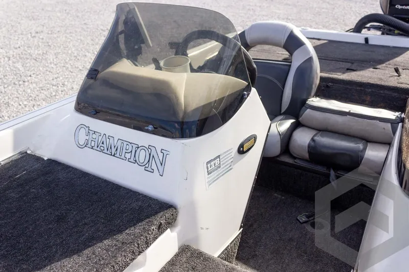 Slide: The Image of Interior of a 2000 Champion 193 CX boat with steering console and seating. - 23