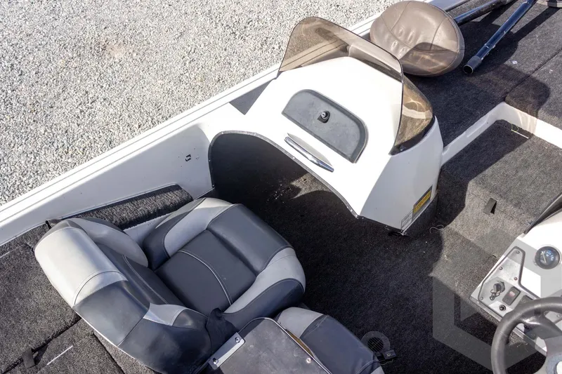 Slide: The Image of Interior of a 2000 Champion 193 CX boat with seating and dashboard. - 26