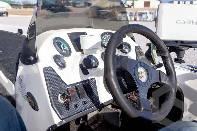 Slide: The Image of Steering console of a 2000 Champion 193 CX boat with gauges and Garmin device. - 27