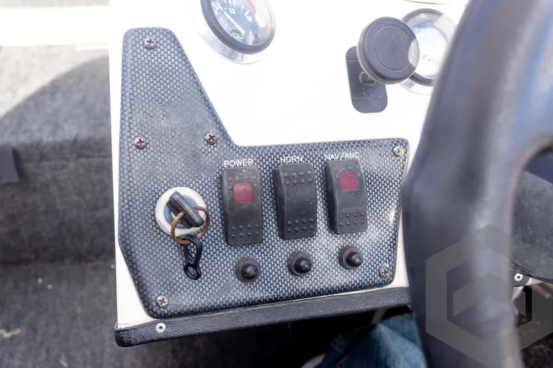 Slide: The Image of Control panel of a 2000 Champion 193 CX boat with switches and voltmeter. - 28