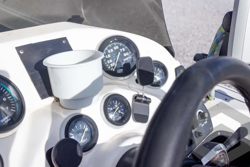 Slide: The Image of Dashboard of a 2000 Champion 193 CX boat with gauges and steering wheel. - 29