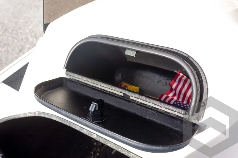 Slide: The Image of Open storage compartment in 2000 Champion 193 CX boat with American flag inside. - 34