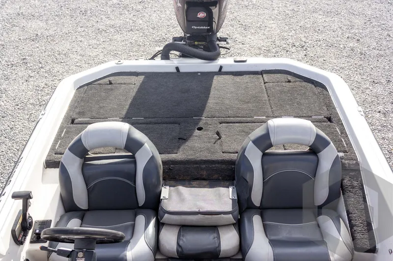 Slide: The Image of 2000 Champion 193 CX boat interior with dual seats and motor, on gravel surface. - 35