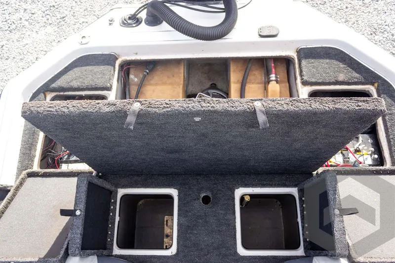 Slide: The Image of Open storage compartments on a 2000 Champion 193 CX boat deck. - 37