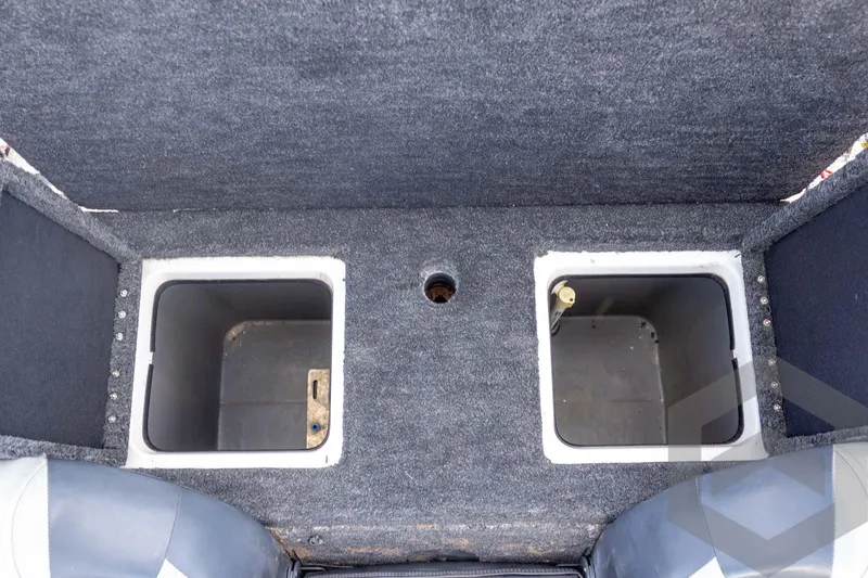 Slide: The Image of Interior storage compartments of a 2000 Champion 193 CX boat. - 38