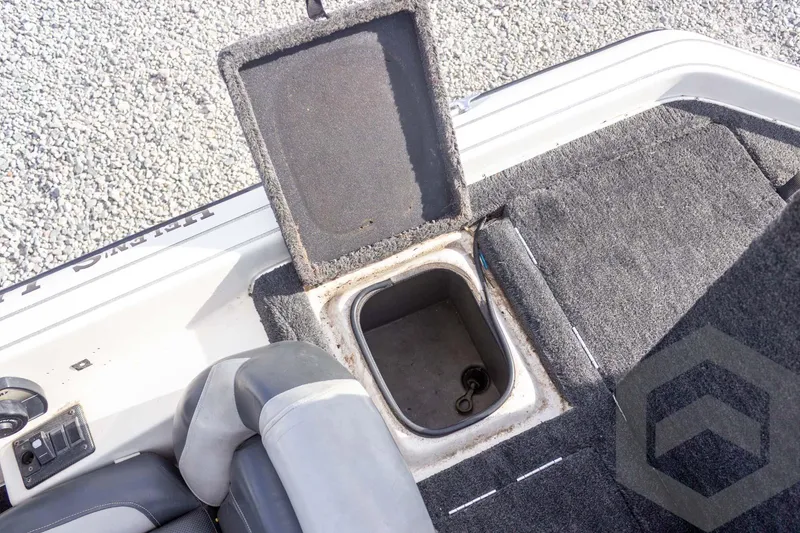 Slide: The Image of Open storage compartment in 2000 Champion 193 CX boat with carpeted interior. - 40