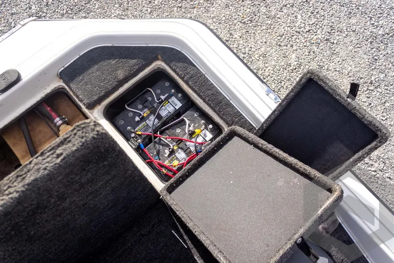 Slide: The Image of Open battery compartment of 2000 Champion 193 CX boat, showing wiring and connections. - 41