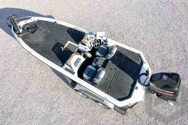 Slide: The Image of 2000 Champion 193 CX boat with Mercury engine, aerial view on gravel surface. - 47
