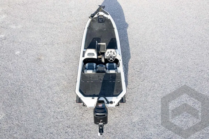 Slide: The Image of Aerial view of a 2000 Champion 193 CX boat on gravel surface. - 48