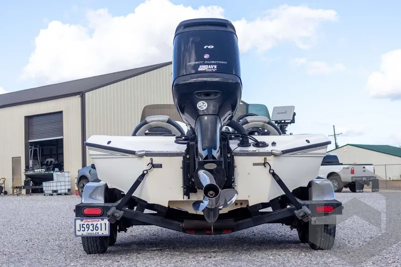 Slide: The Image of Rear view of a 2000 Champion 193 CX boat on a trailer, parked outdoors. - 9