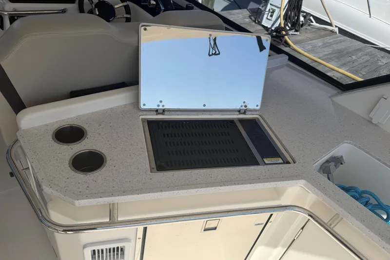 Slide: The Image of 2023 Aquila 36 Sport boat interior with kitchenette and grill setup. - 11