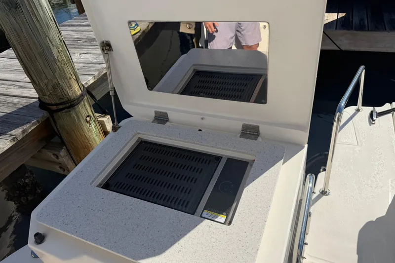 Slide: The Image of Outdoor grill on 2023 Aquila 36 Sport boat, docked by wooden pier. - 13
