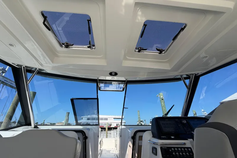 Slide: The Image of Interior view of 2023 Aquila 36 Sport boat cockpit with modern controls and skylights. - 15