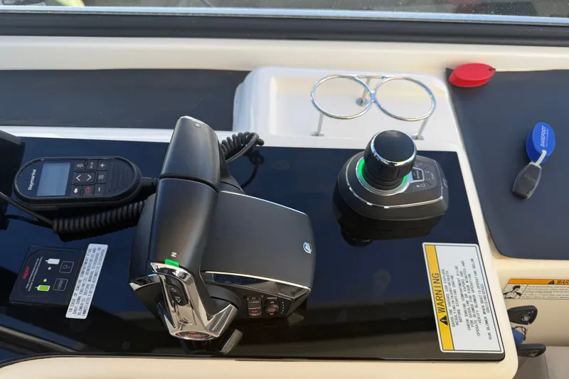 Slide: The Image of Control panel of 2023 Aquila 36 Sport boat with joystick and throttle controls. - 18