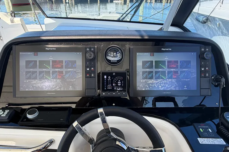 Slide: The Image of Helm of 2023 Aquila 36 Sport with dual Raymarine displays and steering wheel. - 19
