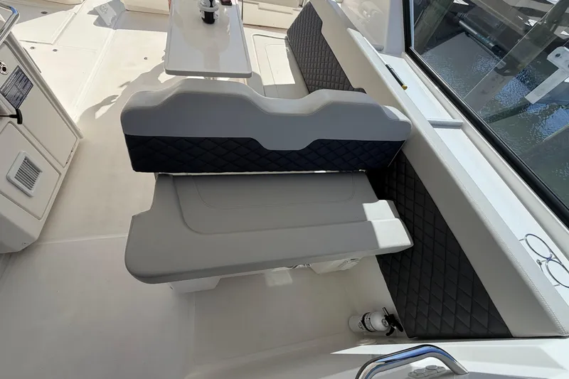 Slide: The Image of 2023 Aquila 36 Sport interior seating with quilted upholstery and table. - 23