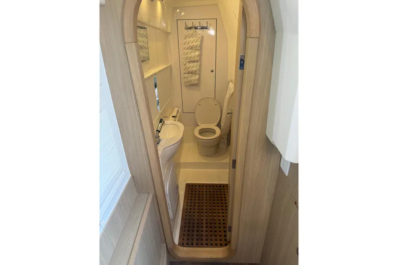 Slide: The Image of Bathroom interior of 2023 Aquila 36 Sport yacht, featuring modern fixtures and wooden accents. - 27