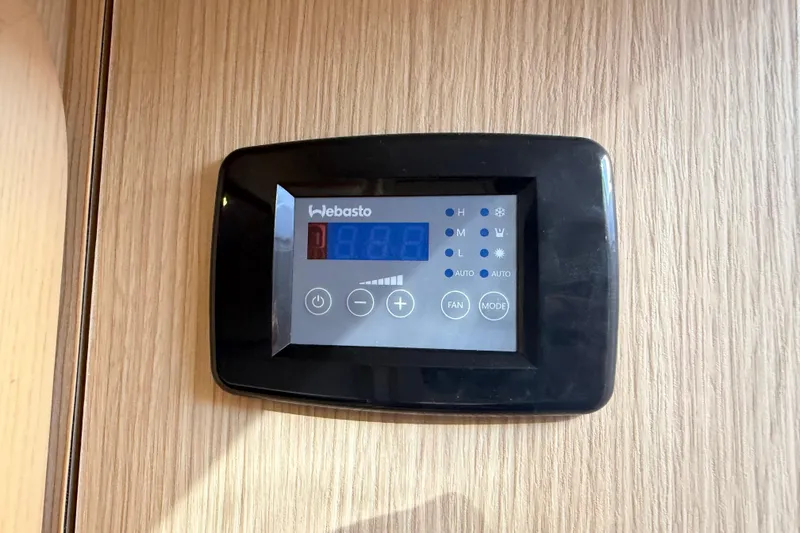 Slide: The Image of Digital control panel on 2023 Aquila 36 Sport boat, mounted on wooden surface. - 29