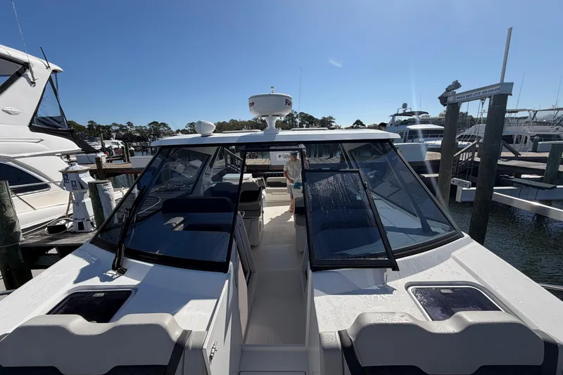 Slide: The Image of 2023 Aquila 36 Sport boat docked at marina under clear blue sky. - 32
