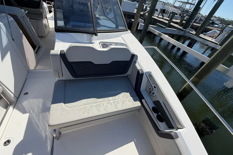 Slide: The Image of 2023 Aquila 36 Sport boat interior with cushioned seating and cup holders. - 34
