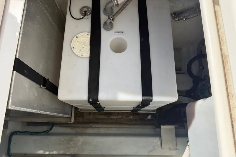 Slide: The Image of 2023 Aquila 36 Sport boat storage compartment with secured white tank. - 35