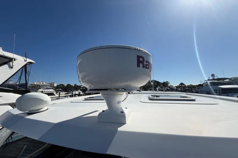 Slide: The Image of 2023 Aquila 36 Sport yacht with Raymarine radar on deck under clear blue sky. - 36