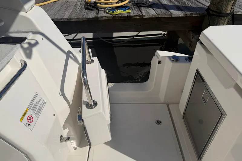 Slide: The Image of 2023 Aquila 36 Sport boat interior with stainless steel railing and storage compartment. - 7