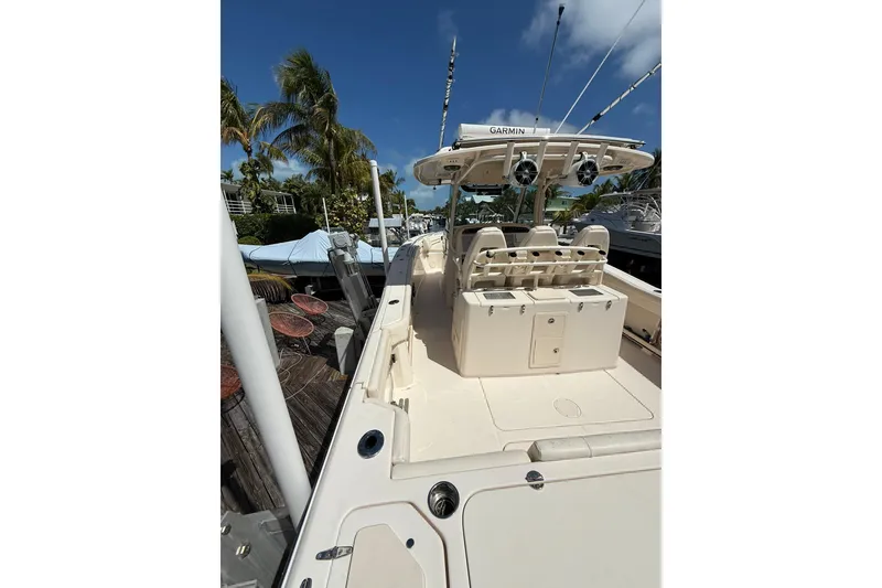 Slide: The Image of 2021 Grady-White Canyon 336 boat docked, featuring spacious deck and modern equipment. - 11