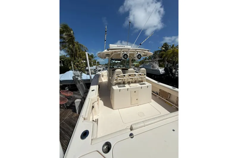 Slide: The Image of 2021 Grady-White Canyon 336 boat docked under clear blue sky. - 12
