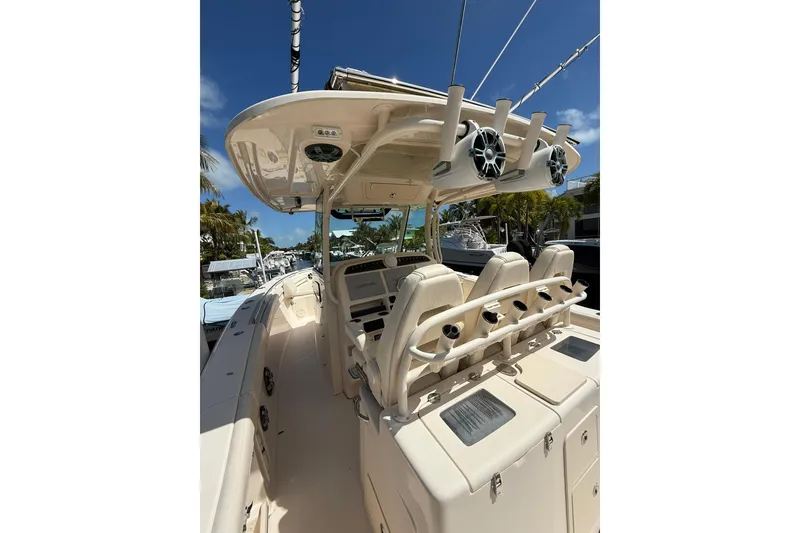 Slide: The Image of 2021 Grady-White Canyon 336 boat interior with helm and seating under clear blue sky. - 19