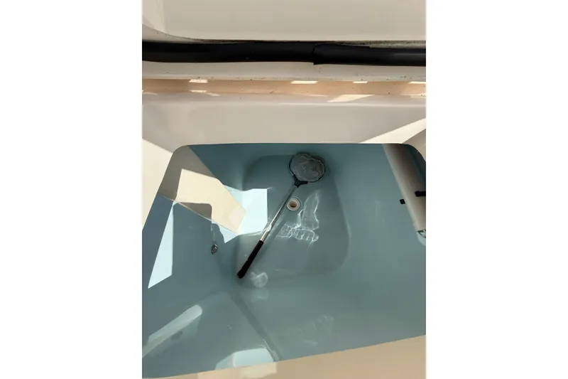 Slide: The Image of 2021 Grady-White Canyon 336 livewell with net, showcasing clean design and functionality. - 21