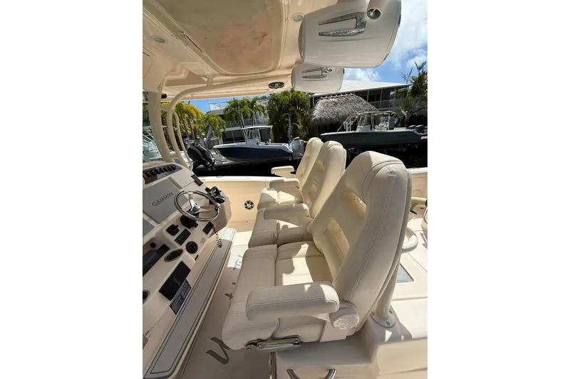 Slide: The Image of 2021 Grady-White Canyon 336 boat interior with plush seating and modern controls. - 23