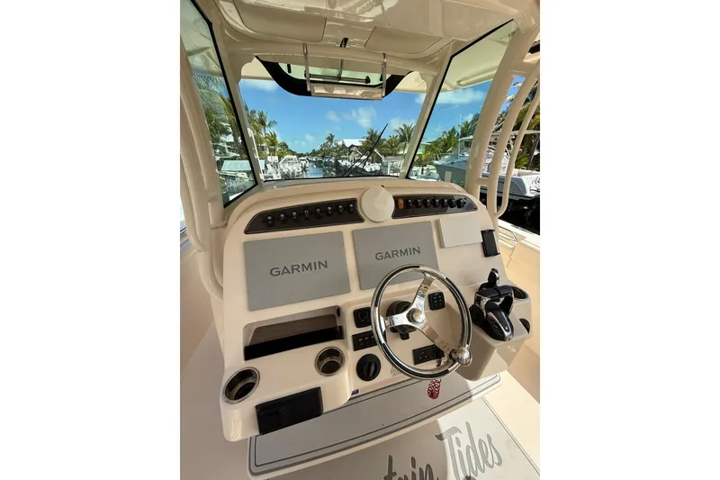 Slide: The Image of 2021 Grady-White Canyon 336 helm with Garmin displays and steering wheel. - 25