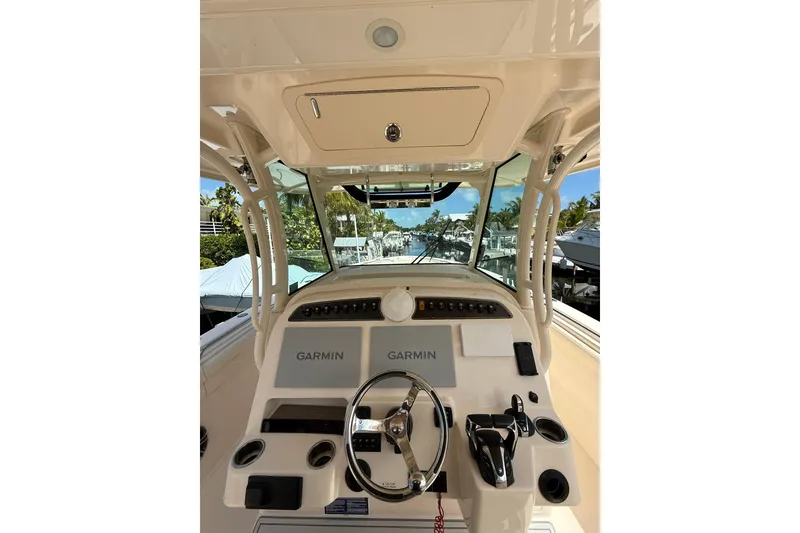 Slide: The Image of 2021 Grady-White Canyon 336 helm with Garmin displays and steering wheel. - 26