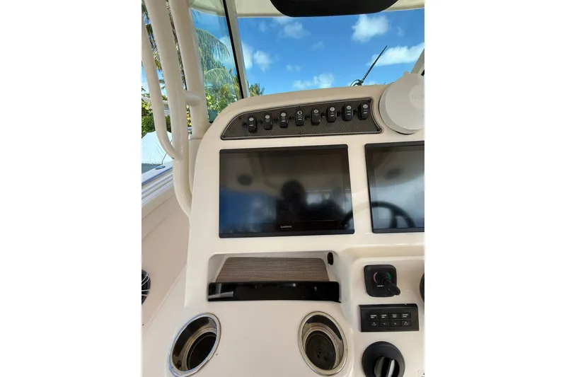 Slide: The Image of 2021 Grady-White Canyon 336 dashboard with dual screens and control panel. - 27
