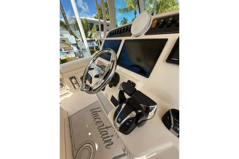 Slide: The Image of 2021 Grady-White Canyon 336 helm with steering wheel and control panel. - 32