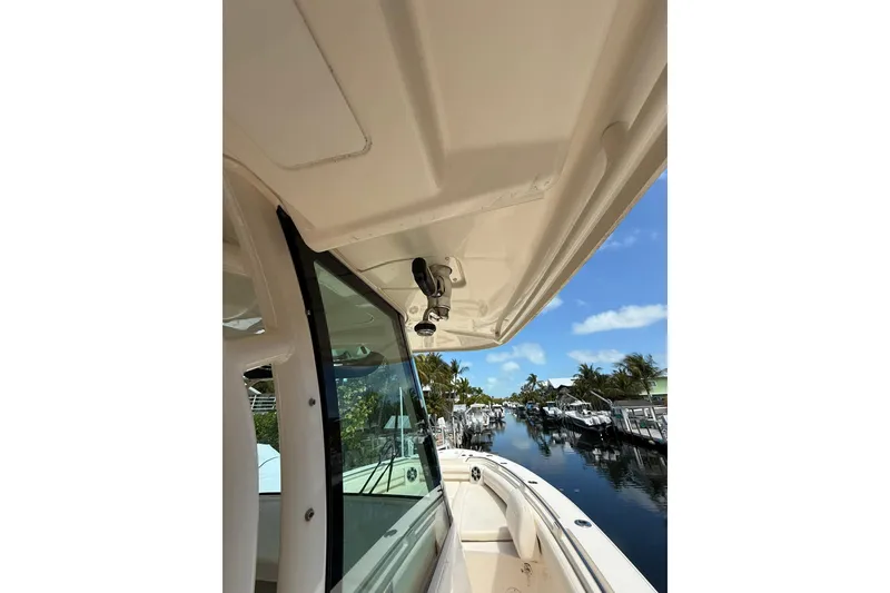 Slide: The Image of 2021 Grady-White Canyon 336 boat docked by a scenic canal. - 33