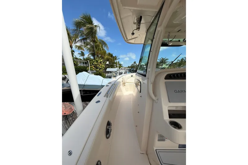 Slide: The Image of 2021 Grady-White Canyon 336 boat deck with palm trees and blue sky background. - 37