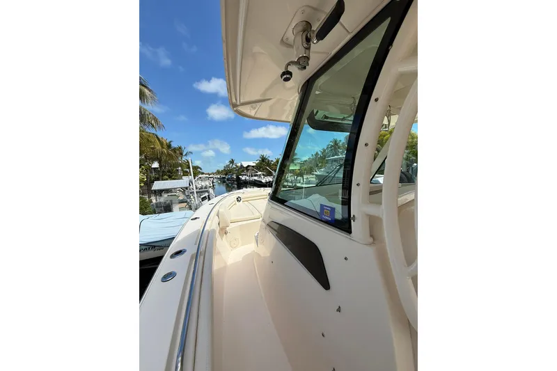 Slide: The Image of 2021 Grady-White Canyon 336 boat docked under clear blue sky. - 39