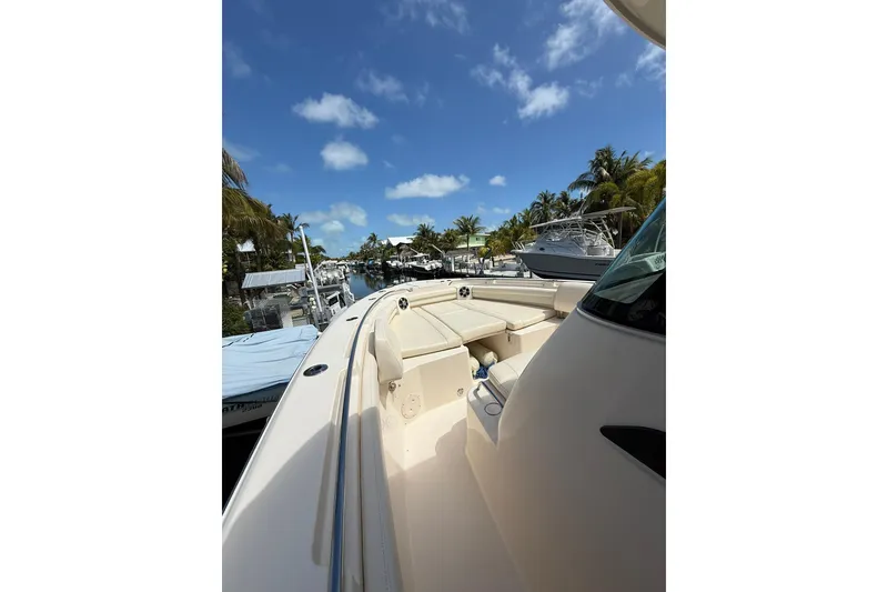 Slide: The Image of 2021 Grady-White Canyon 336 boat docked under a clear blue sky. - 40