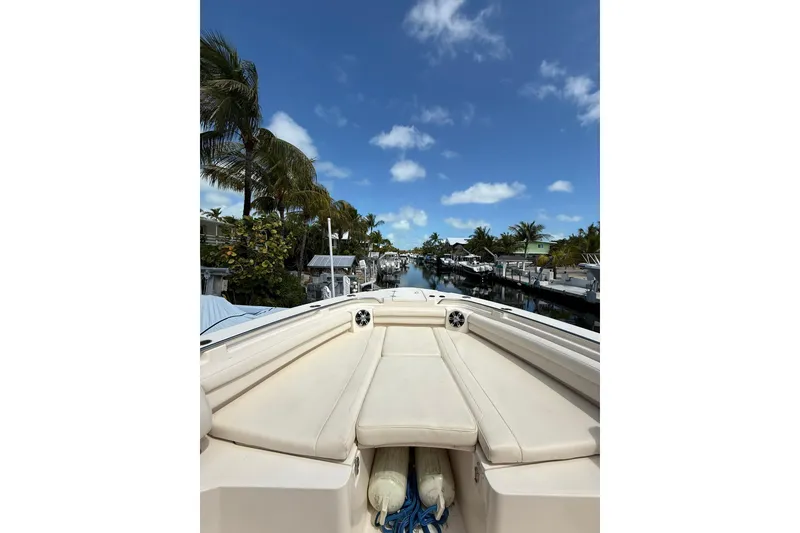 Slide: The Image of 2021 Grady-White Canyon 336 boat docked under clear blue sky. - 44