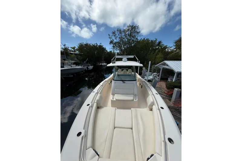 Slide: The Image of 2021 Grady-White Canyon 336 boat docked, featuring spacious seating and clear skies. - 45
