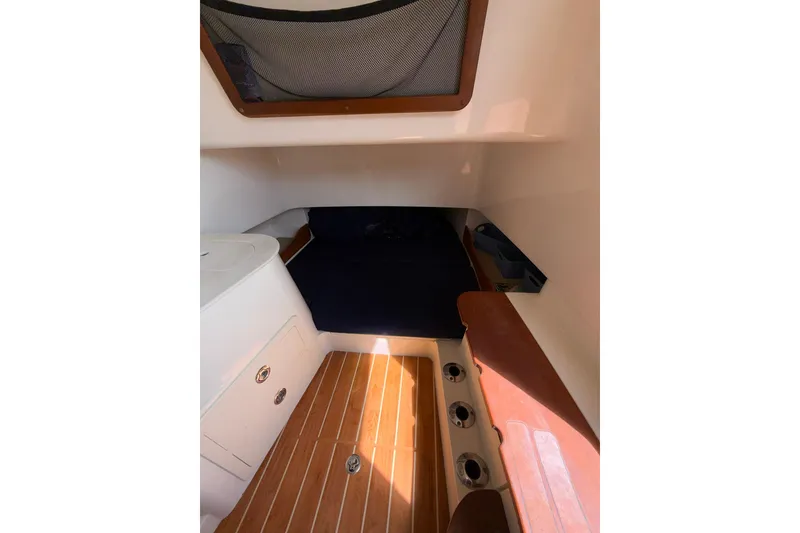 Slide: The Image of 2021 Grady-White Canyon 336 cabin interior with wood flooring and storage compartments. - 49